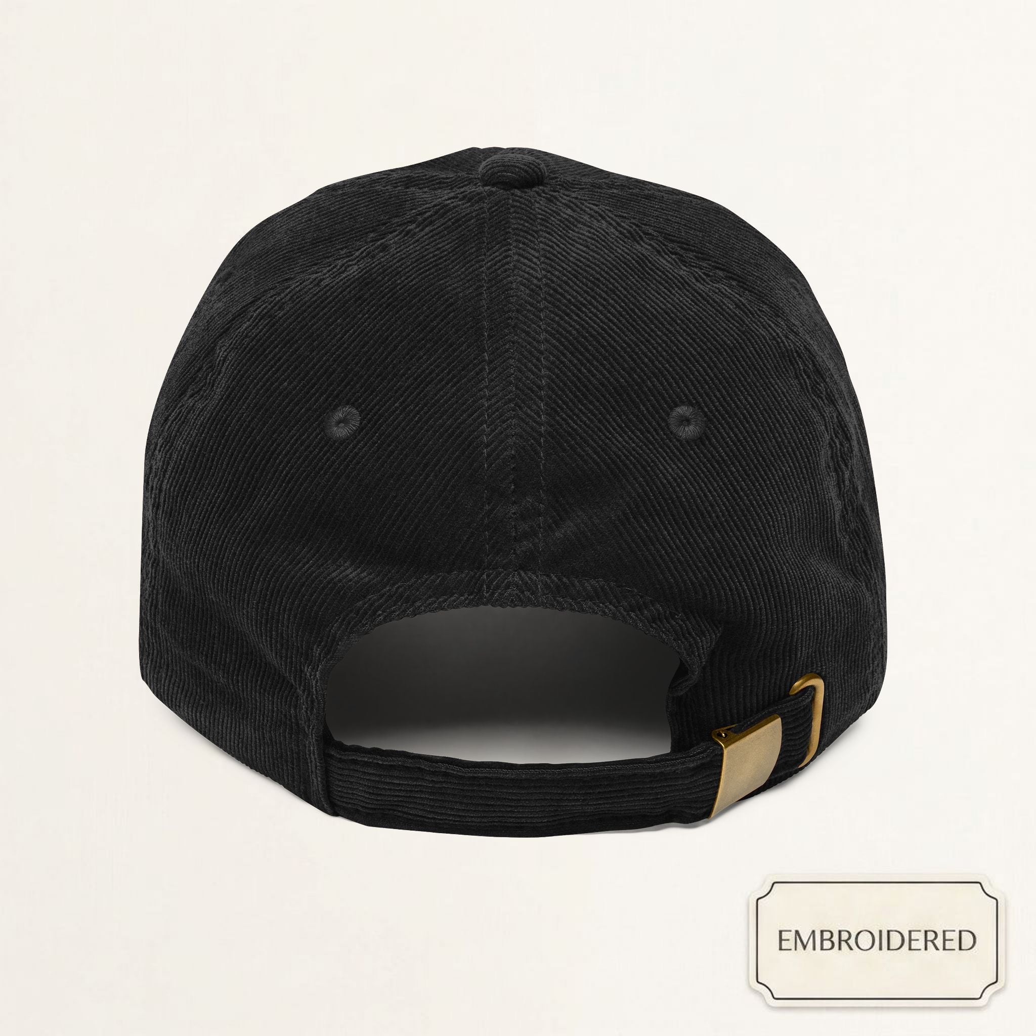 Model wearing a black corduroy cap with off-white embroidered RAISED ON TRAILS text