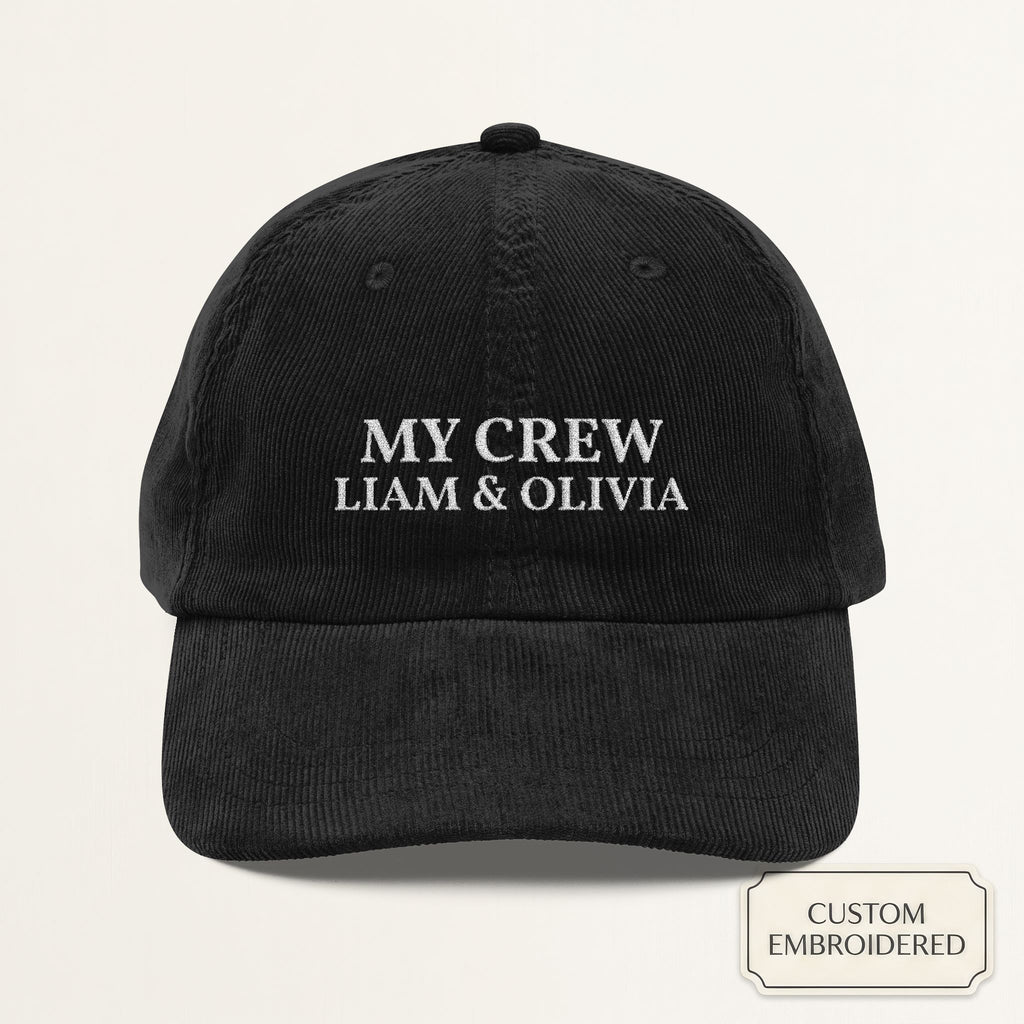 Personalized black corduroy cap embroidered with MY CREW and custom names — front view