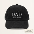 Black corduroy dad cap with off-white embroidered DAD EST. 2024 custom year text on the front