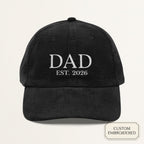 Black corduroy dad cap with off-white embroidered DAD EST. 2024 custom year text on the front