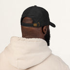 Back view of a black corduroy Boy Dad cap showing the adjustable metal buckle closure
