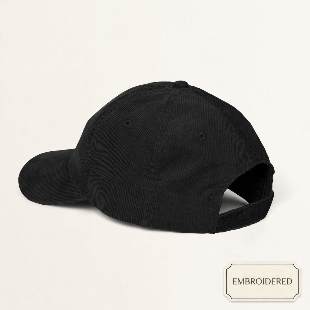 Model wearing a black corduroy cap with off-white embroidered DADDY text