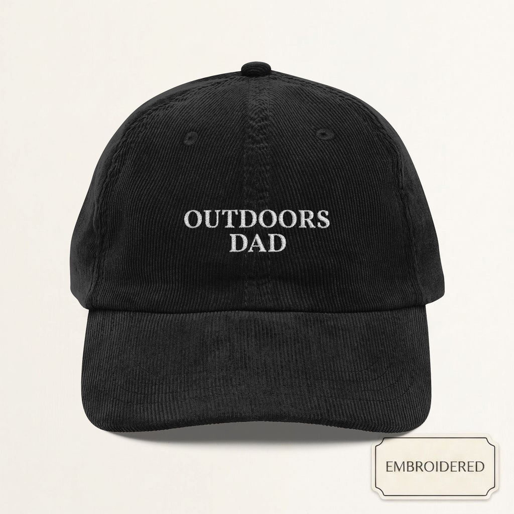 Black corduroy dad cap with small off-white embroidered OUTDOORS DAD text on the front panel