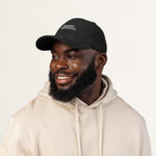 The Epic Granddad embroidered corduroy cap — angled front view, black with off-white thread