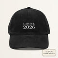 Personalized black corduroy dad cap embroidered with DAD EST YEAR — front view